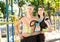 Sports couple with kinesiology taping posing outdoors.