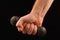 Sports dumbbell in the hand of a man