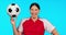 Sports, face and happy woman with soccer ball in studio for training, exercise and fitness on blue background. Portrait