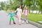 Sports family-mother with children on roller skates in the Park