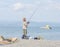 Sports fisherman on the coast of the small tourist town of Pefkochori