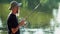 Sports fisherman fishing on lake, using fishing lures;