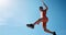 Sports, fitness and black woman jumping with blue sky background from below. Running, exercise and jump, woman training