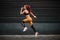 Sports and fitness concept - woman with fit body jumping and running, exercising