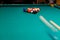Sports game of billiards on a green cloth. Multi-colored billiard balls with numbers