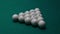 Sports game of billiards on a green cloth. White billiard balls in a wooden triangle with numbers on a pool table. 15