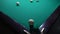 A sports game of billiards, pool or snooker on a billiard table with a green cloth.Hitting billiard balls with a cue. Cue kick.Par