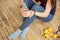 Sports girl in a blue shirt and blue leggings sits on the floor and holds in her hands sports supplements in capsules