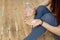 Sports girl in a blue shirt and blue leggings sits on the floor and holds in her hands sports supplements in capsules