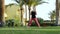 Sports girl doing basic exercises from yoga standing barefoot on the lawn. Brunette in stylish sports clothes does