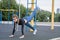 Sports girl doing exercises on the buttocks on the playground.