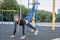 Sports girl doing exercises on the buttocks on the playground.