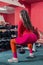 Sports girl leggings does squats from dumbbells sports a gym. sports fitness and weightlifting