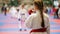 Sports girl teenager wears a mouthguard - female sportsmen on karate - ready for fight