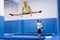 Sports girl training side split on trampoline