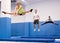 Sports girl training side split on trampoline