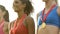 Sports girls smiling, standing with medals on podium, proud of achievements