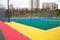 Sports ground for playing basketball with rubberized material tracks yellow lilac pink in the city outdoors. Sport is a healthy li