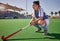 Sports, hockey and woman relax on field during match, thinking and planning a game strategy. Field hockey, coach and