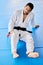 Sports, injury and pain in legs on karate fitness dojo floor for tournament, training or workout. Professional athlete