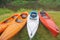 Sports kayaks on the shore of the pond, four kayaks on the Bank of the river