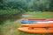 Sports kayaks on the shore of the pond, four kayaks on the Bank of the river