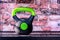 Sports kettlebell with green handle. Sports equipment for muscle building