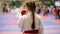 Sports kids - teenager girl sportsmen on karate use a protective mouthguard