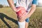 Sports, knee pain and hands on field or football competition, training and exercise injury with anatomy and red overlay