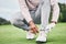 Sports, laces and shoes of man on golf course for training, games and tournament match. Ready, start and tying with male