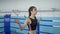 Sports lifestyle, fitness woman performs skipping exercises on boxing ring in sports club