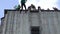 Sports man descend down on rope from high house wall in city centre