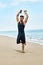 Sports. Man Doing Expander Exercises Outdoor On Beach. Body Workout