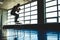 sports man jumps on a special platform in the gym opposite the window. silhouette shot