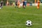 Sports outdoor background. Soccer ball on the field. Football competition tournament match in the blurred background