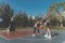 Sports and recreation concept young male teenagers practicing dribbling basketball in the court after school