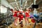 Sports Santa Claus with girls in Santa`s costumes in the gym on