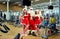 Sports Santa Claus with girls in Santa`s costumes in the gym on