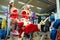 Sports Santa Claus with girls in Santa`s costumes in the gym.