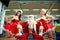 Sports Santa Claus with girls in Santa`s costumes in the gym.