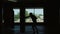 Sports: Silhouette of man is practicing kick in a boxing gym. Slow motion.