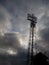 Sports stadium floodlights and stormy sky.