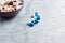 Sports Supplements and Bowl of Granola with Yogurt, Nuts, Raisins, Cranberries and Chia Seeds in Background.