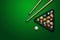 Sports theme with billiards, a full set of billiard balls, cue, on a green background. top view, flat lay, copy space, snooker.