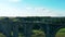 Sports tourist is crossing the desolated bridge and enjoying the view