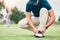 Sports, tying and shoes of man on golf course for training, games and tournament match. Ready, start and tie laces with