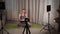sports and vlogging concept - woman or blogger with camera on tripod record online yoga lesson at home. Video studio at