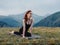 sports woman exercise yoga meditation mountains fresh air