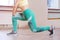 Sports. Woman at the gym doing stretching exercises and smiling on the floor