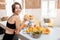 Sports woman with healthy food on the kitchen